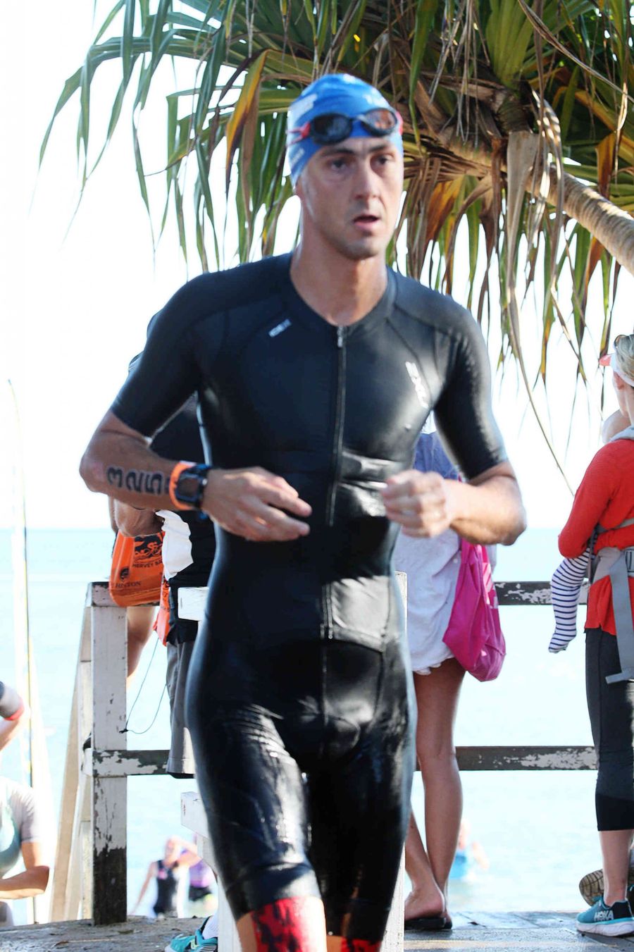 Giuseppe Gambarini esce dall'acqua in muta durante la frazione di nuoto del triathlon Hervey Bay 100 in Australia